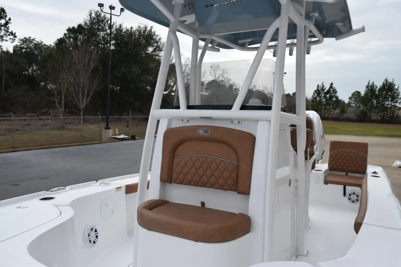 Slide: The Image of 2026 Sea Hunt BX 22 BR boat with tan seating and white deck, parked outdoors. - 15