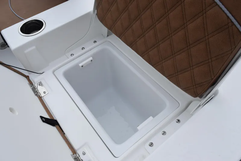 Slide: The Image of 2026 Sea Hunt BX 22 BR boat storage compartment with cushioned seat and cup holder. - 22