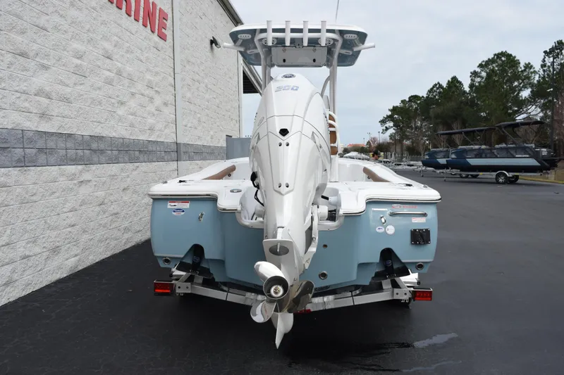 Slide: The Image of 2026 Sea Hunt BX 22 BR boat with powerful outboard motor, parked outdoors. - 5