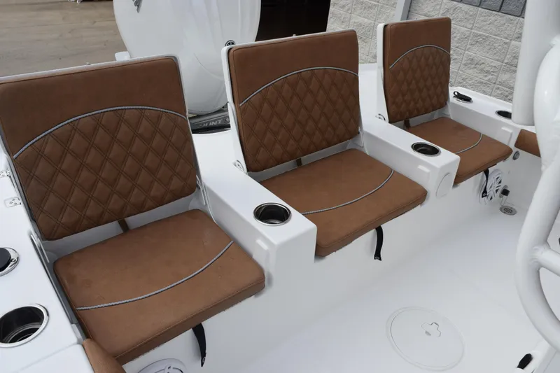 Slide: The Image of 2026 Sea Hunt BX 22 BR boat seats with brown diamond-pattern upholstery and integrated cup holders. - 7
