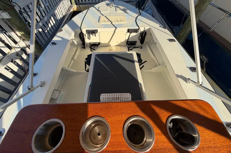 Slide: The Image of 2024 Custom Florida Flats CC boat interior with seating and cup holders. - 10