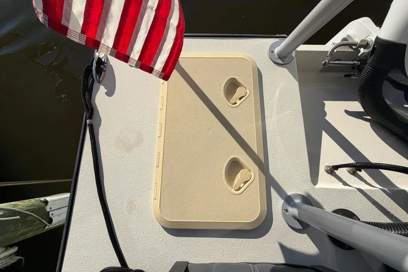 Slide: The Image of 2024 Custom Florida Flats CC boat deck with hatch and American flag. - 17