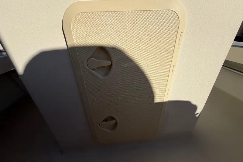 Slide: The Image of Hatch cover on 2024 Custom Florida Flats CC boat, featuring textured surface and handles. - 23