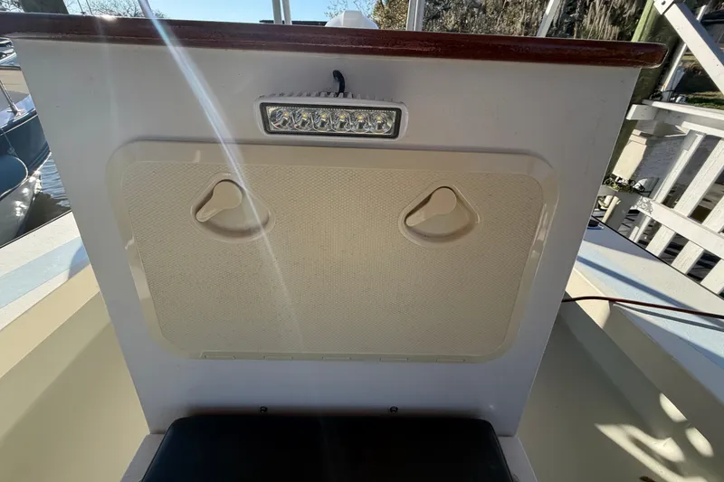Slide: The Image of 2024 Custom Florida Flats CC boat interior with storage compartment and LED light. - 26