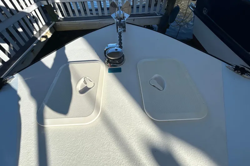 Slide: The Image of 2024 Custom Florida Flats CC boat deck with storage hatches and anchor chain. - 32