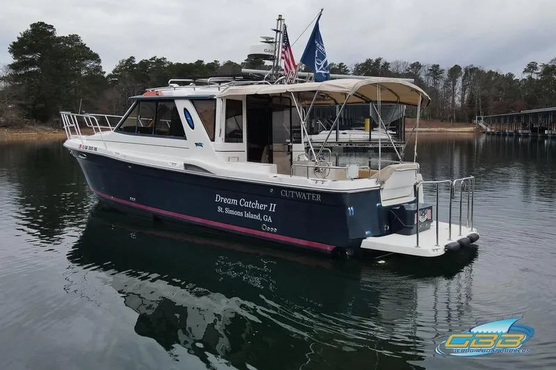 Slide: The Image of 2013 Cutwater C-28 boat on calm water with forested shoreline background. - 11