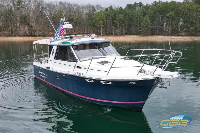 Slide: The Image of 2013 Cutwater C-28 boat docked in a marina with canopy and flags. - 14