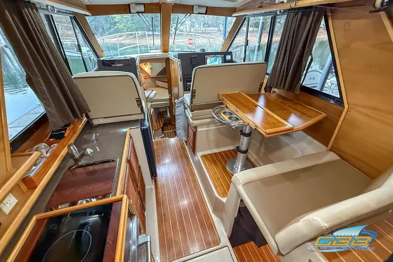 Slide: The Image of 2013 Cutwater C-28 interior with microwave, TV, and wooden cabinetry. - 17