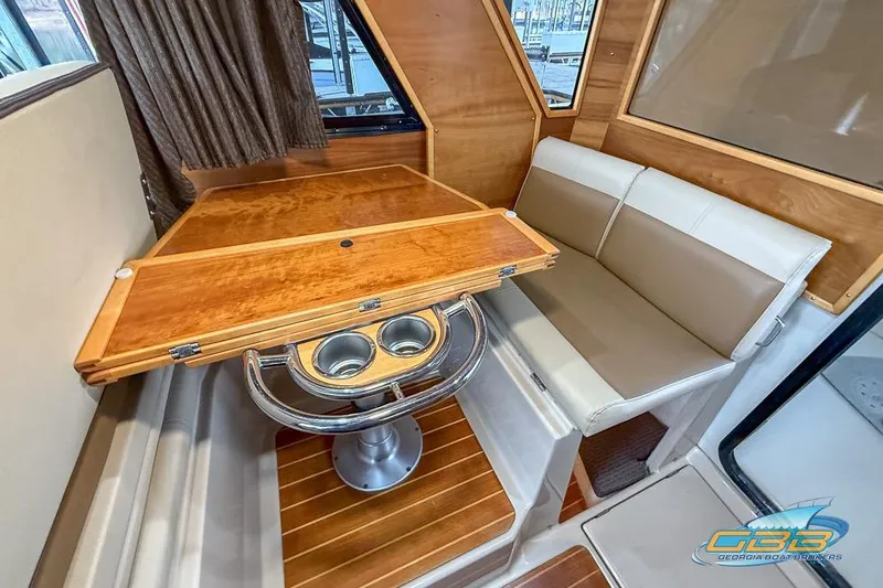 Slide: The Image of Interior of 2013 Cutwater C-28 boat with wood finishes and compact kitchen area. - 22