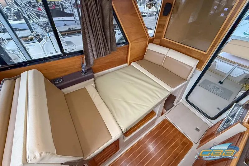 Slide: The Image of Interior of 2013 Cutwater C-28 boat with cozy seating and wooden table. - 23