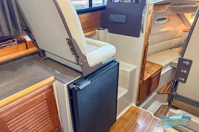 Slide: The Image of 2013 Cutwater C-28 boat interior with kitchenette, wood cabinetry, and compact appliances. - 39