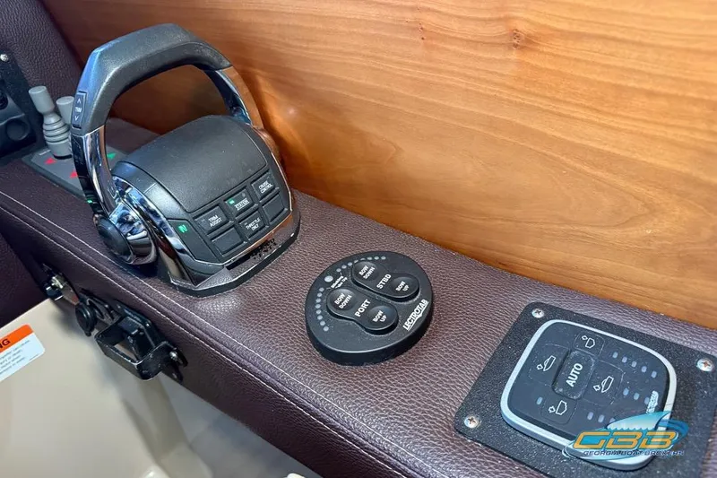 Slide: The Image of Control panel of a 2013 Cutwater C-28 boat with steering and navigation controls. - 44