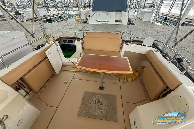 Slide: The Image of 2013 Cutwater C-28 boat interior with seating and table, docked at marina. - 64