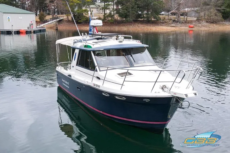 Slide: The Image of 2013 Cutwater C-28 boat "Dream Catcher II" on calm water near forested shoreline. - 7