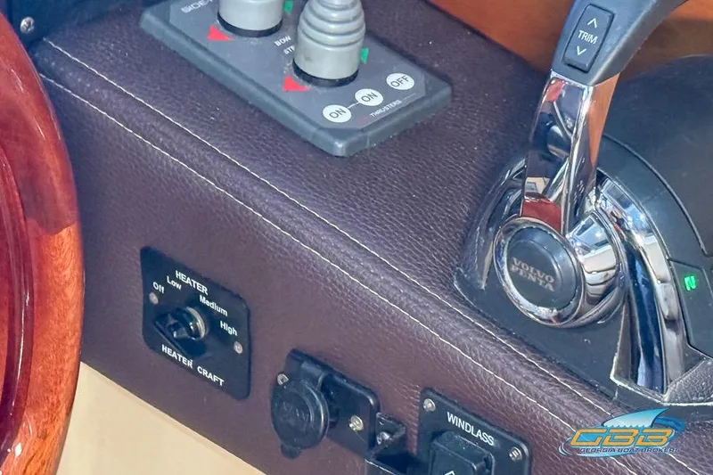 Slide: The Image of 2013 Cutwater C-28 boat with flags, docked under a metal canopy. - 72