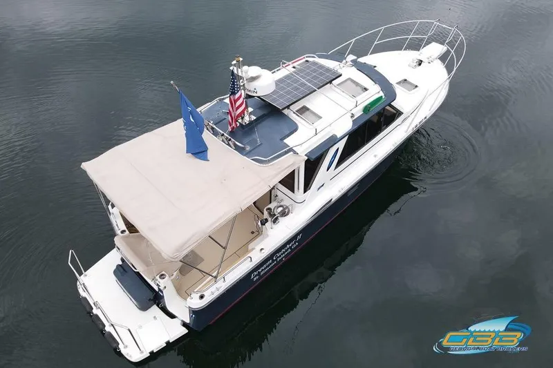Slide: The Image of 2013 Cutwater C-28 boat docked, rear view with flags and calm water. - 8