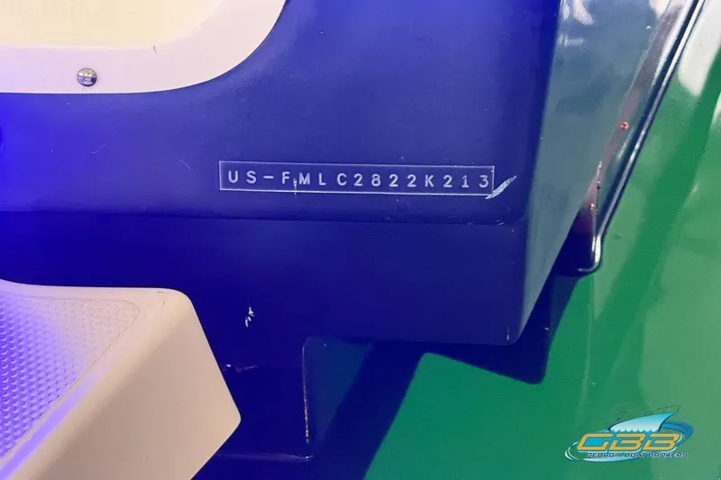 Slide: The Image of Trailer for 2013 Cutwater C-28 boat on grassy yard, near a building. - 84