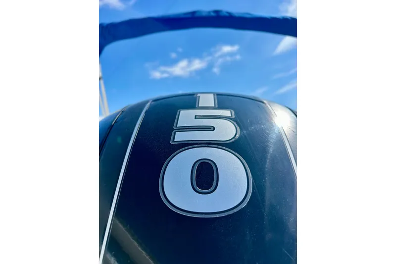 Slide: The Image of Outboard motor with "150" label on a 2018 Starcraft 2000 OB Limited boat. - 12