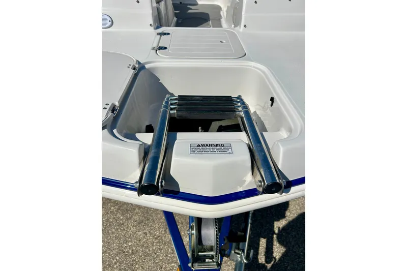 Slide: The Image of 2018 Starcraft 2000 OB Limited boat with a retractable swim ladder. - 14