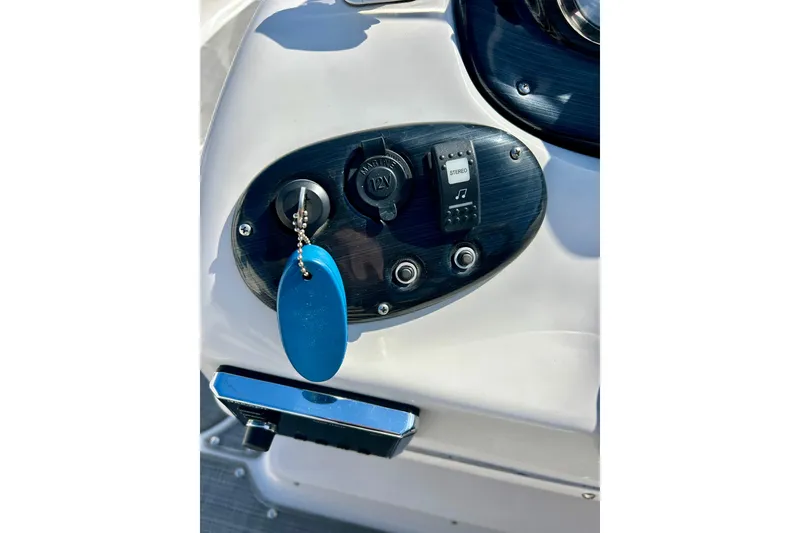 Slide: The Image of Control panel of 2018 Starcraft 2000 OB Limited boat with key and stereo switch. - 25
