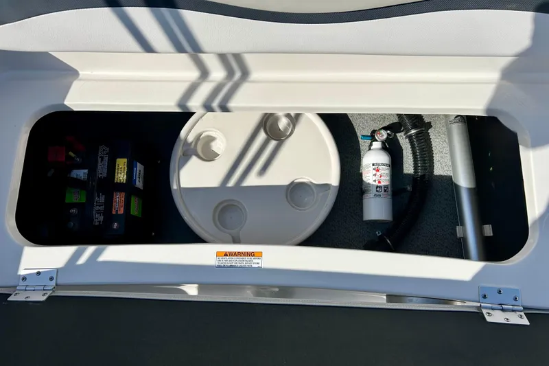 Slide: The Image of Storage compartment in a 2018 Starcraft 2000 OB Limited boat with battery and fire extinguisher. - 31