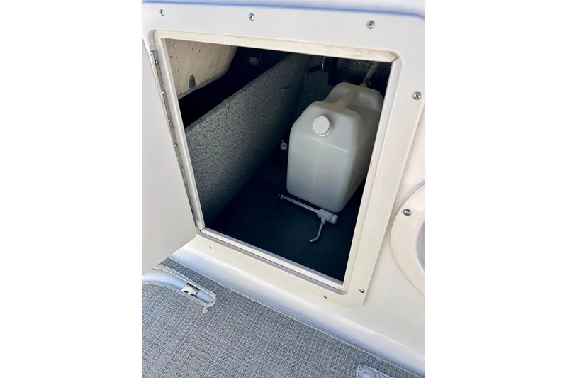 Slide: The Image of Storage compartment in 2018 Starcraft 2000 OB Limited boat with white container inside. - 36