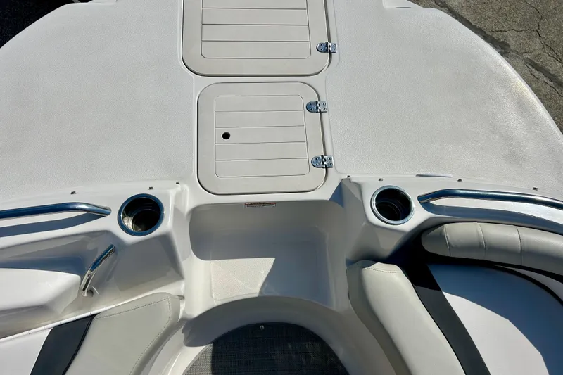 Slide: The Image of 2018 Starcraft 2000 OB Limited boat interior with cup holders and storage compartments. - 38