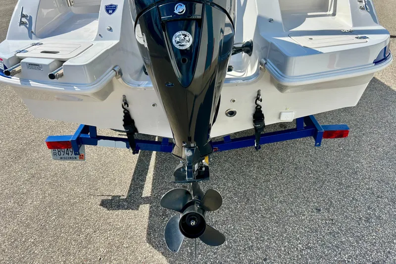 Slide: The Image of 2018 Starcraft 2000 OB Limited boat on trailer, featuring outboard motor. - 47