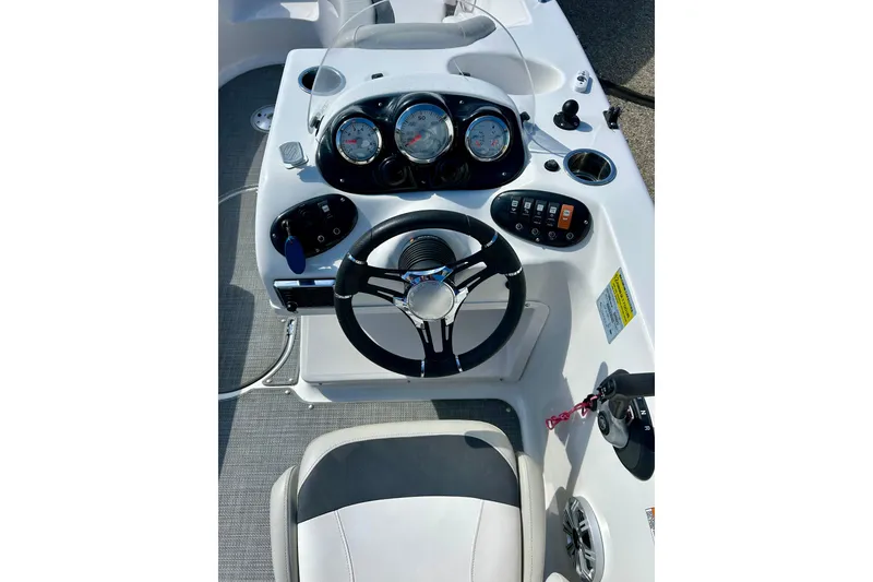 Slide: The Image of 2018 Starcraft 2000 OB Limited boat dashboard with steering wheel and gauges. - 58