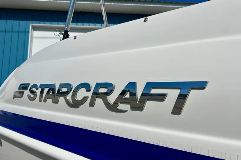 Slide: The Image of 2018 Starcraft 2000 OB Limited boat with chrome logo on white hull. - 9