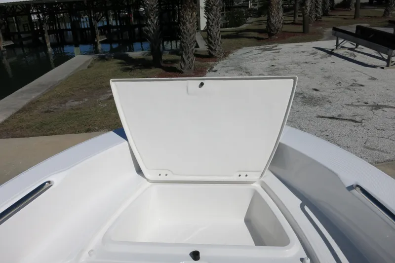 Slide: The Image of 2026 Robalo R160 Center Console boat with open storage compartment. - 12