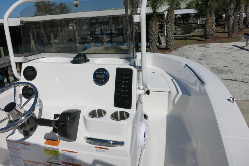 Slide: The Image of 2026 Robalo R160 Center Console boat interior with steering wheel and control panel. - 13