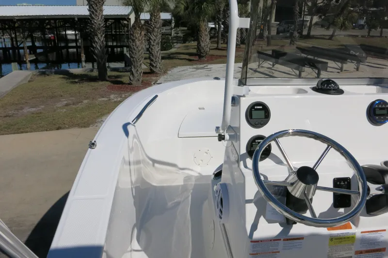 Slide: The Image of 2026 Robalo R160 Center Console boat interior with steering wheel and dashboard controls. - 14