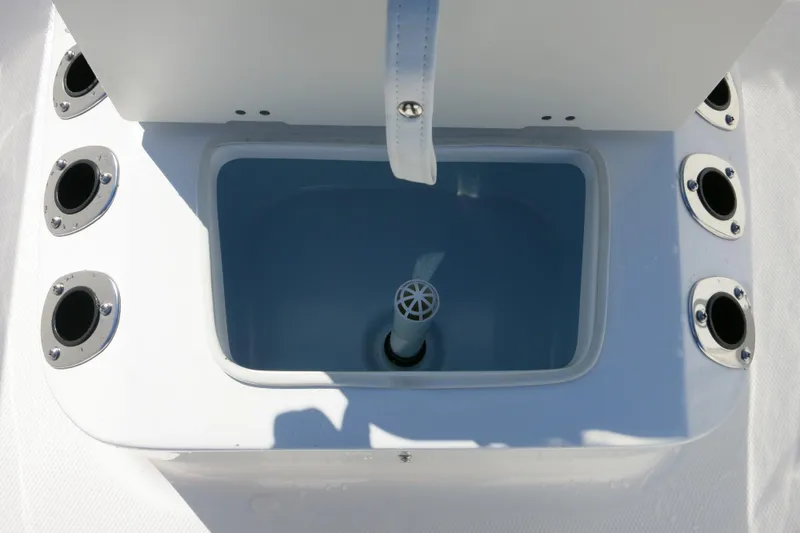 Slide: The Image of 2026 Robalo R160 Center Console livewell with rod holders. - 17