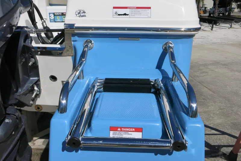 Slide: The Image of 2026 Robalo R160 Center Console boat with blue and white exterior, featuring a rear ladder. - 22