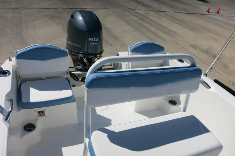 Slide: The Image of 2026 Robalo R160 Center Console boat interior with Yamaha 90 engine, featuring blue and white seating. - 9