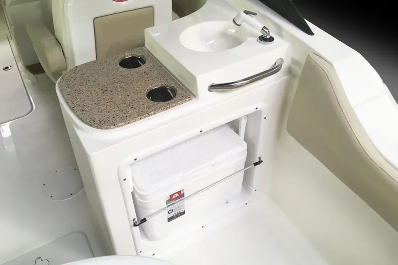 Slide: The Image of Manufacturer Provided Image: 2018 NauticStar 2302 Legacy Dual Console boat interior with sink and cooler storage. - 12