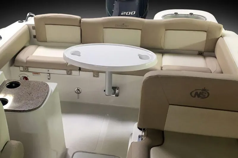 Slide: The Image of Manufacturer Provided Image: 2018 NauticStar 2302 Legacy Dual Console boat interior with seating and table. - 13