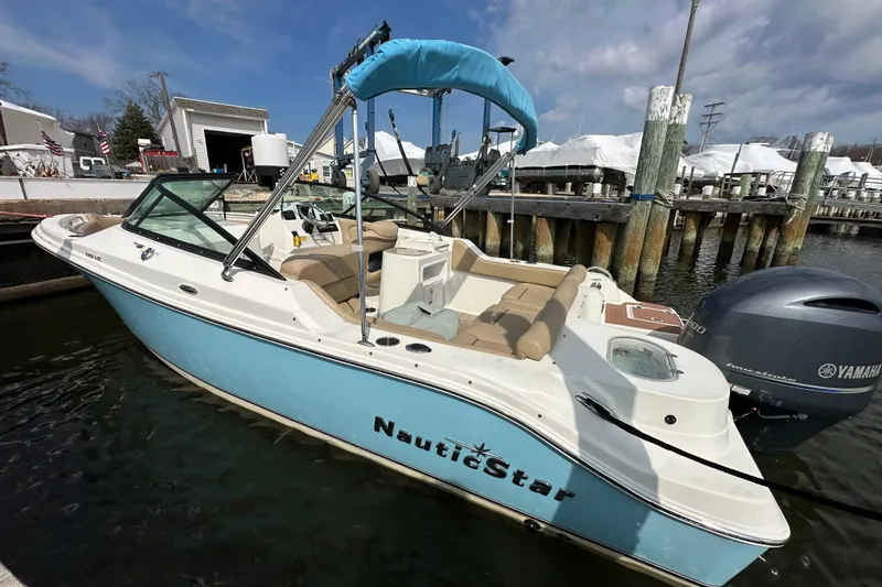 Slide: The Image of 2018 NauticStar 2302 Legacy Dual Console boat docked in marina. - 15