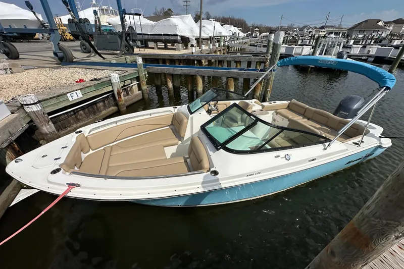 Slide: The Image of 2018 NauticStar 2302 Legacy Dual Console boat docked in marina. - 16