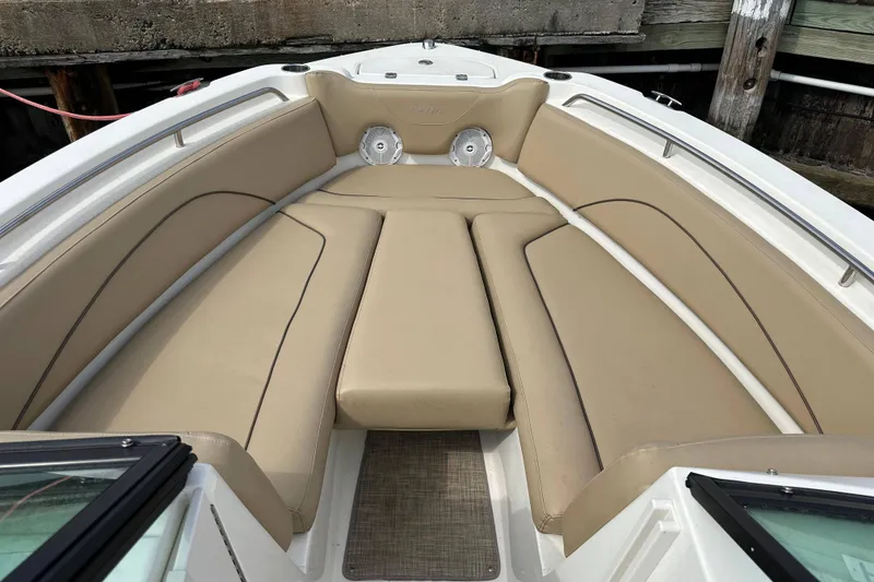 Slide: The Image of 2018 NauticStar 2302 Legacy Dual Console boat with beige seating and spacious layout. - 17
