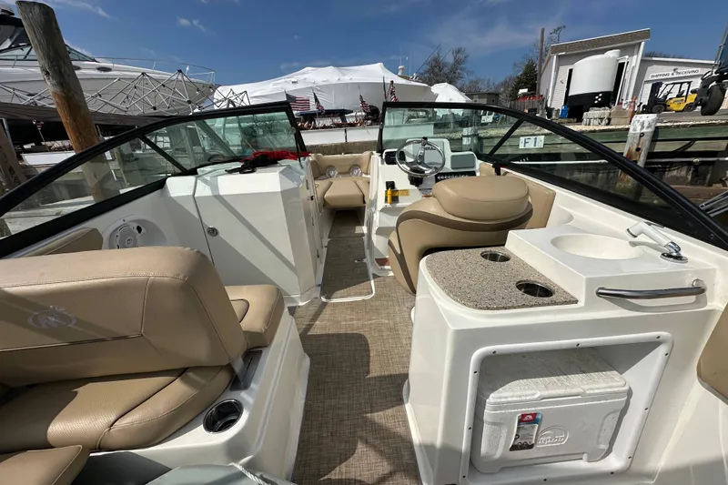 Slide: The Image of 2018 NauticStar 2302 Legacy Dual Console boat interior with beige seating and helm. - 21