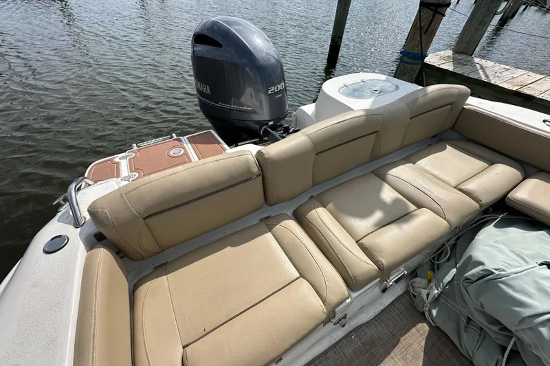 Slide: The Image of 2018 NauticStar 2302 Legacy Dual Console boat with Yamaha 200 engine, docked by water. - 22