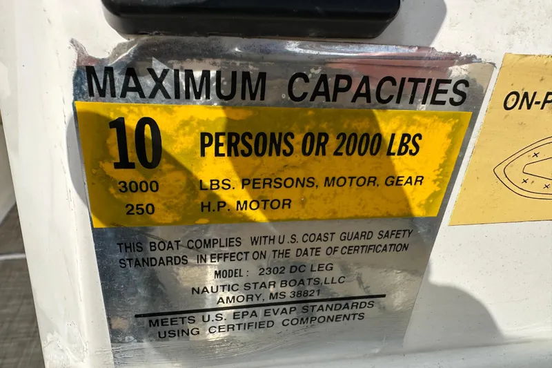 Slide: The Image of 2018 NauticStar 2302 Legacy Dual Console capacity label, 10 persons or 2000 lbs, 250 HP motor. - 23