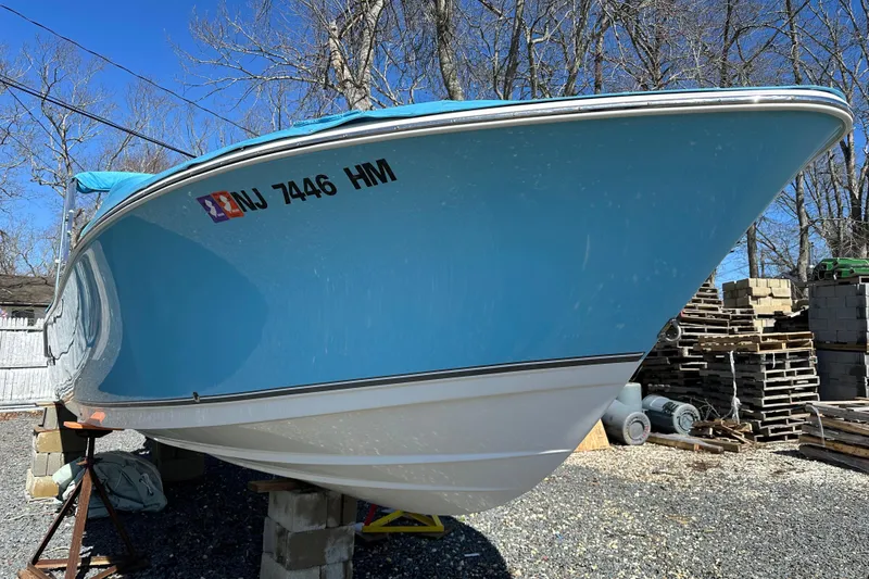 Slide: The Image of 2018 NauticStar 2302 Legacy Dual Console boat on dry land, blue hull, registration NJ 7446 HM. - 25