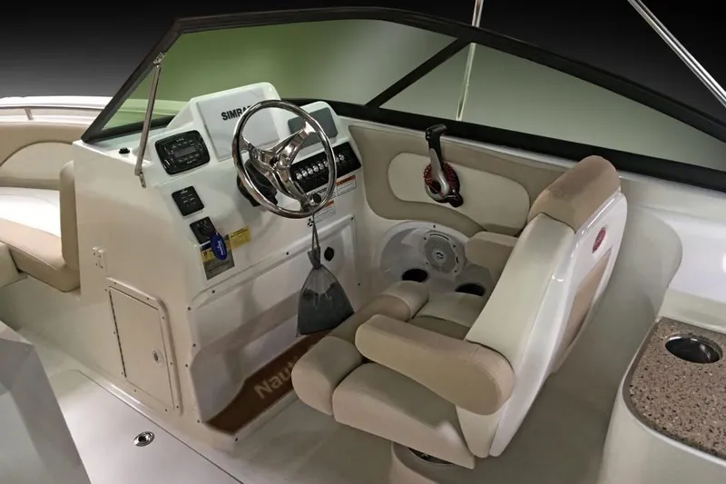 Slide: The Image of Manufacturer Provided Image: 2018 NauticStar 2302 Legacy Dual Console boat cockpit with steering wheel and captain's chair. - 9