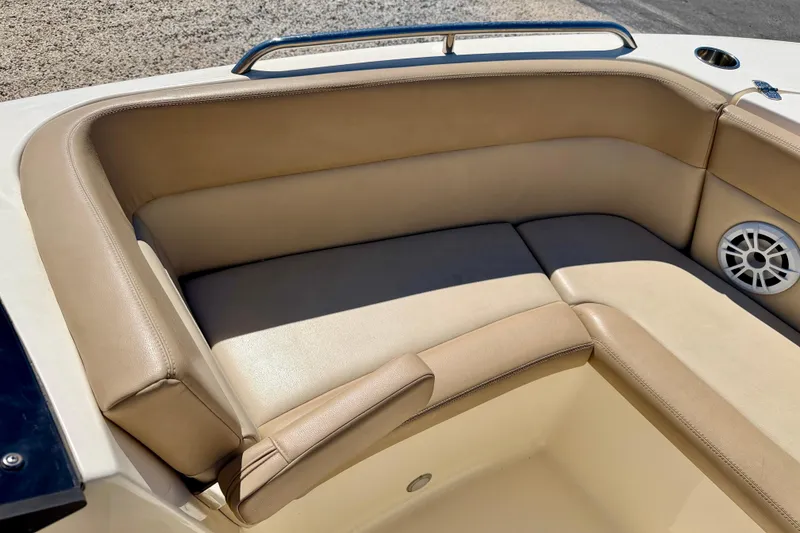 Slide: The Image of 2023 Scout 215 Dorado boat interior with beige seating and speaker. - 10
