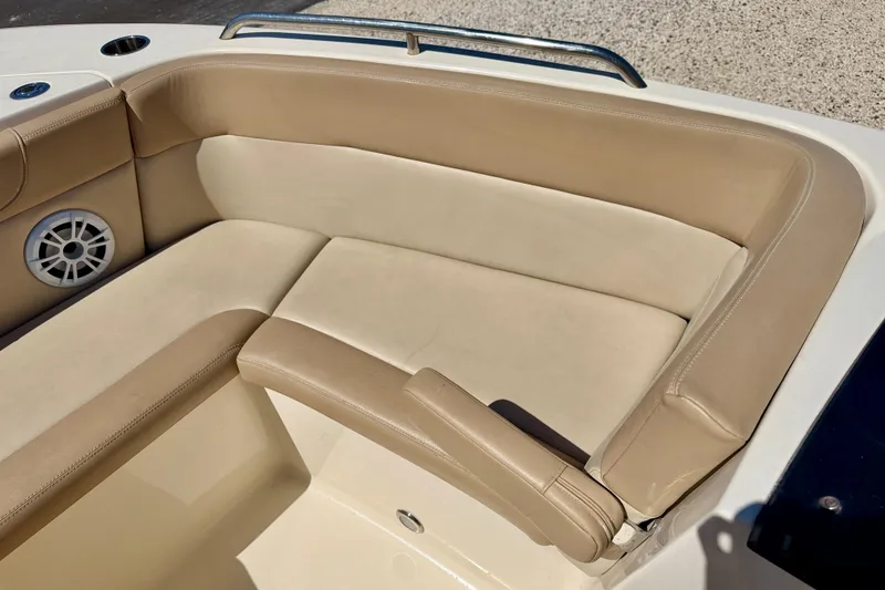 Slide: The Image of 2023 Scout 215 Dorado boat interior with beige seating and speaker. - 11