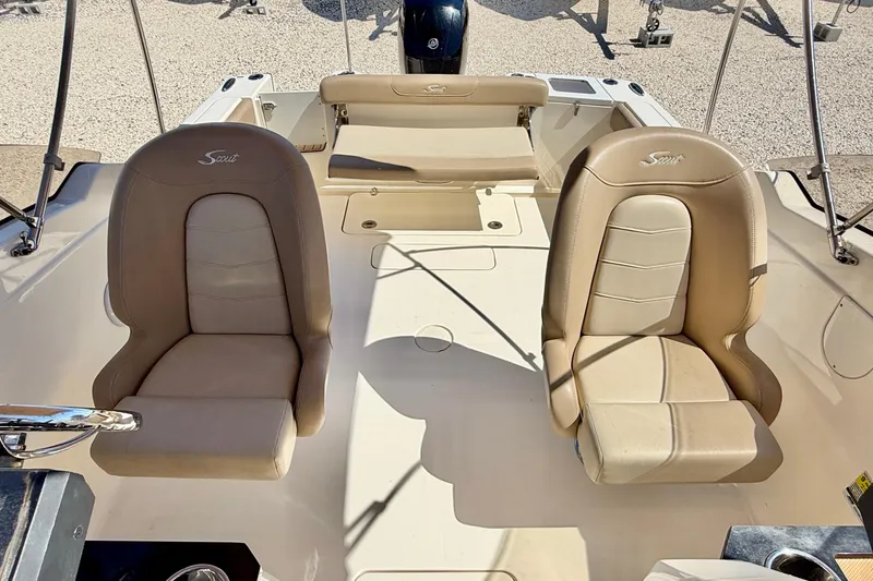 Slide: The Image of 2023 Scout 215 Dorado boat interior with beige seating and steering wheel. - 12