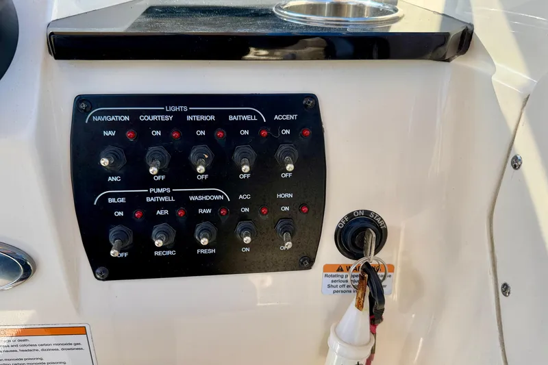Slide: The Image of Control panel of 2023 Scout 215 Dorado boat with various switches and ignition key. - 17
